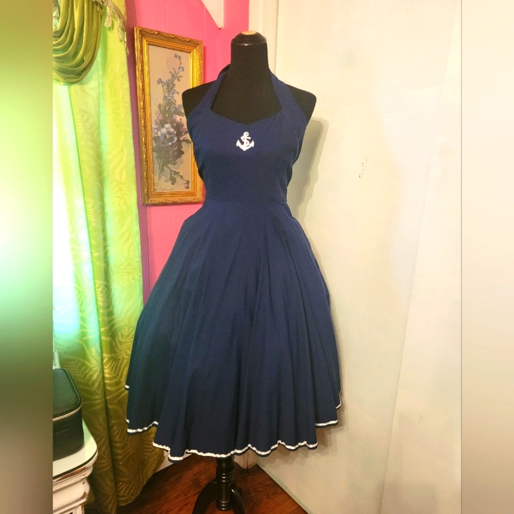 Navy blue dress with anchor embroidery.